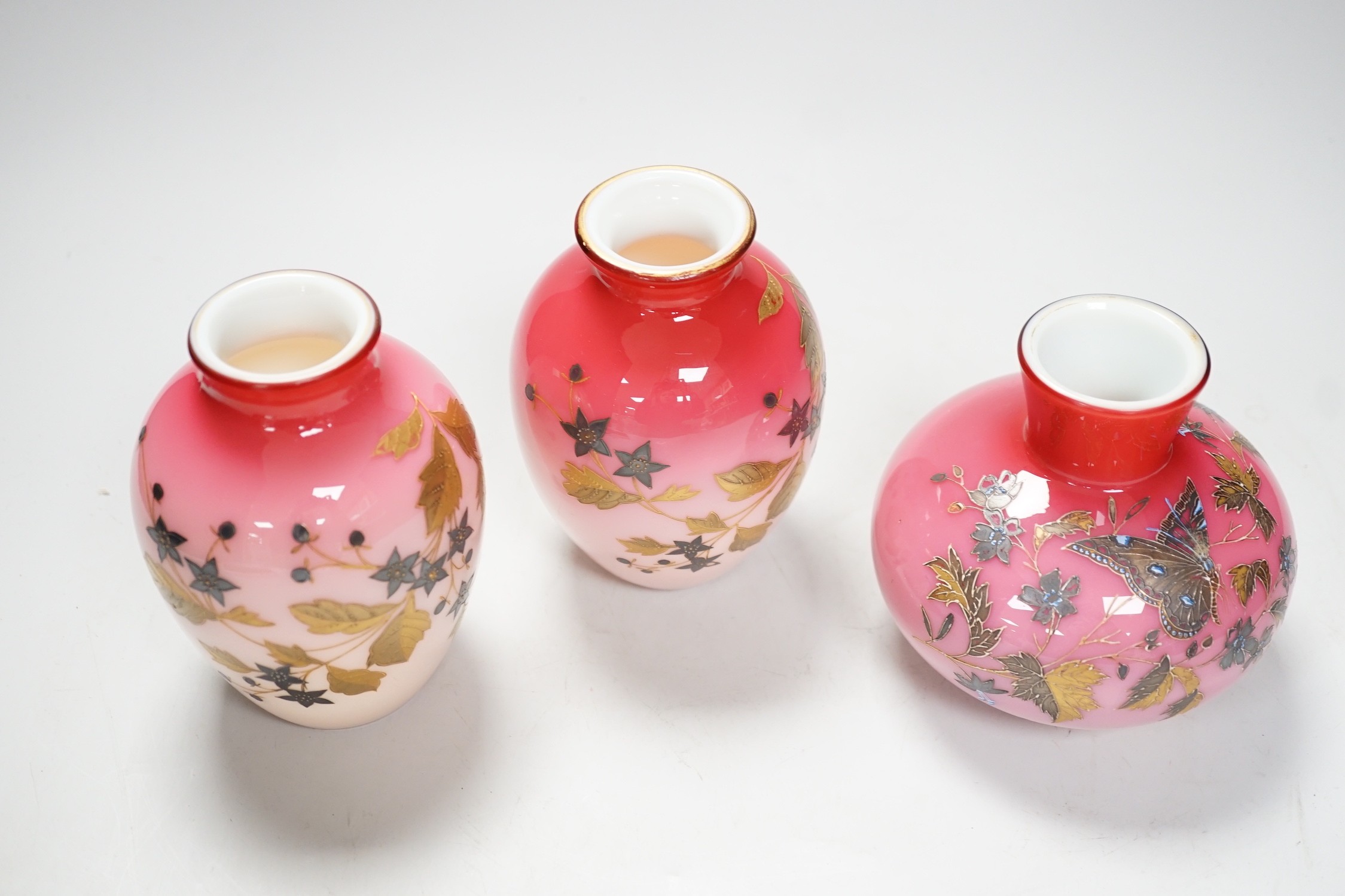 A pair of Stourbridge peach blow vases and another, tallest 13cm